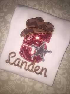 a white shirt with a cowboy hat and star on it