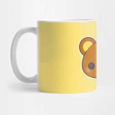 a yellow coffee mug with a brown bear on it's side and black eyes