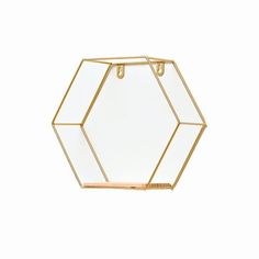 a gold and white hexagonal glass holder