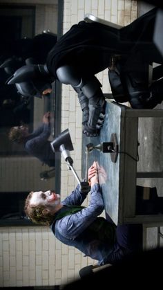 a man holding onto the handle of a metal box with hammers stuck in it