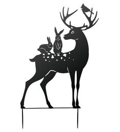 the silhouette of a deer with two birds on it's back, and another bird perched on its hind legs