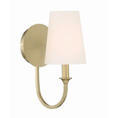 a wall light with a white shade on the side and a gold finish to it