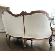 a white couch sitting on top of a hard wood floor