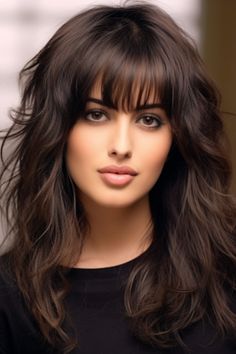 The glossy long layers with arched bangs create a sophisticated look. It suits most face shapes because the arched bangs focus attention on your eyes, and long layers add volume and movement. Click here to check out more trending long layered hair with bangs. Straight Across Bangs With Layers, Long Sideswept Bangs Long Hair, Shoulder Length Hair With Bangs Side Part, Medium Length Haircut With Bangs And Layers, Brown Hair With Bangs And Layers, Feathered Bangs Long Hair, Bangs With Curls, Bangs Sideswept, Modern Bangs