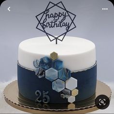 a birthday cake decorated with blue and white frosting, hexagonal shapes and the number twenty five