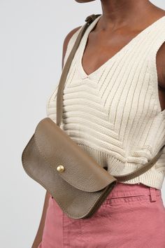 The Faba Bag in Otter is a versatile and stylish, neutral shade pouch, that's perfect for elevating your everyday look. With an internal divider and a pocket for credit cards, this bag is secured with a sleek brass pinch and pull release closure. Wear it as a clutch or use the adjustable strap for crossbody or over the shoulder wear. Modern Saddle Bag With Removable Pouch For Daily Use, Modern Taupe Shoulder Bag For Everyday Use, Versatile Belt Bag For On-the-go, Everyday Versatile Flap Bag, Modern Taupe Shoulder Bag For Everyday, Taupe Shoulder Bag With Removable Pouch For On-the-go, Taupe Shoulder Bag With Removable Pouch For Travel, On-the-go Taupe Shoulder Bag With Removable Pouch, Beige Bags With Flat Pocket For Everyday Use