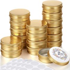 a pile of gold coins sitting next to a small white box with a sticker on it