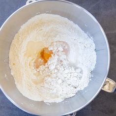 a mixing bowl filled with flour and eggs