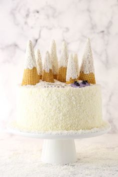 a cake with white frosting and gold decorations