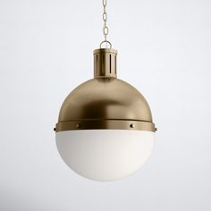 a light hanging from a chain on a white wall