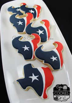 cookies decorated with the colors of the american flag on a white platter, ready to be eaten