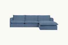 a blue sectional couch sitting on top of a white floor