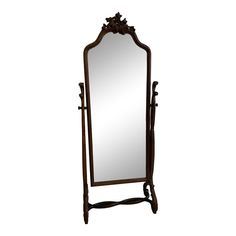 a large mirror sitting on top of a wooden stand