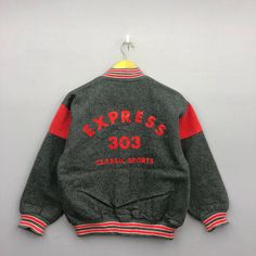 Vintage 90s Express 303 Wool Varsity Baseball Jacket | GF40015.  Manual Measurement (Laying Flat): 1) Chest: 20.5 Inch. 2) Length: 23.5 Inch. 3) Shoulder: 19.5 Inch. 4) Sleeve: 19 Inch. Please check measurements to insure a proper fit. Remember to allow yourself some extra room for movement. You can compare these with something from your closet that fits you well. Fabric Material: Polyester/Wool. In good Condition overall. GF40015.  We do combine shipping. Please Read Before Purchase. Drop your Retro Long Sleeve Varsity Jacket For Sports, Vintage Black Outerwear With Letter Print, Retro Track Jacket With Baseball Collar, Retro Track Jacket With Baseball Collar For Streetwear, Vintage Winter Outerwear With Baseball Collar, Vintage Varsity Jacket With Ribbed Cuffs For Winter, Retro Track Jacket For College In Winter, Retro Track Jacket For Winter College Wear, Vintage Sports Outerwear For Fall