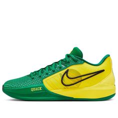 a green and yellow shoe with the word nike written on the upper part of the shoe