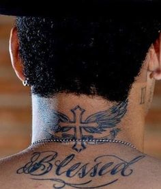 the back of a woman's head with tattoos on it