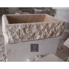 a large stone planter with a plaque on it's side sitting in a room