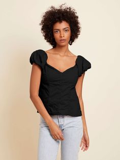 The name says it all. With a sweetheart neckline, buttons down the front and a cute bubble sleeve, it's just the girly touch your outfit needs. (This one comes in Jet Black.) | Angel Top in Jet Black | Ethical Essentials Cute Fitted Top With Square Neck, Cute Fitted Tops With Square Neck, Cute Fitted Square Neck Top, Flirty Fitted Short Sleeve Blouse, Cute Fitted Puff Sleeve Tops, Fitted Top With Gathered Short Sleeves, Tops With Gathered Short Sleeves, Fitted Short Sleeve Tops With Gathered Sleeves, Cute Cotton Puff Sleeve Top