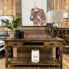 a living room with a cow painting on the wall and a coffee table in front of it