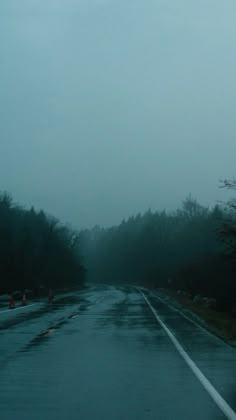 the road is wet from rain and fog