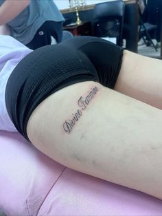 a woman laying on top of a pink chair with her arm tattoo reading, sisters grandma