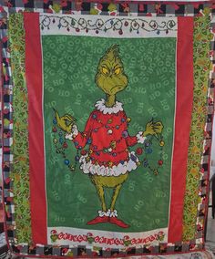 an image of a dr seusster's christmas quilt on display in a store