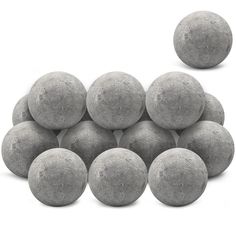 a pile of cement balls sitting next to each other on top of a white surface