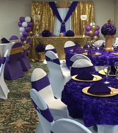 purple and white tables are set up for a party