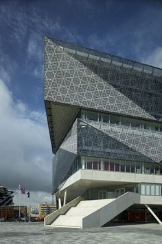 an architectural building with stairs leading up to it's roof and windows on the side