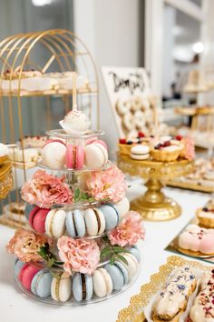 a table topped with lots of desserts and pastries on top of each other