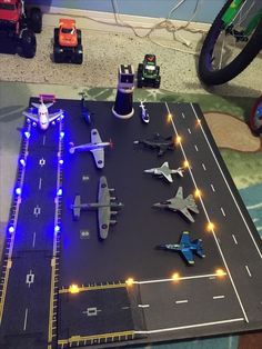 toy airplanes and trucks are on the runway