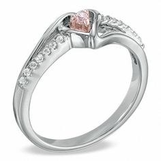 a heart shaped pink diamond ring with white diamonds