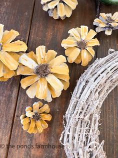 some yellow flowers are sitting next to a wire wreath