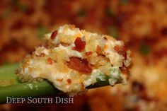 a close up of a spoon with food on it's tip and the words deep south dish