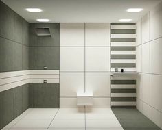 a white and gray tiled bathroom with a urinal, sink and toilet paper dispenser