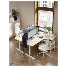 an office desk with a computer monitor and keyboard