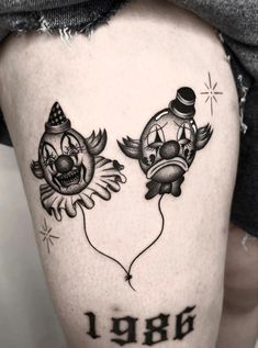 a couple of tattoos that are on the thigh and one has two clowns in it