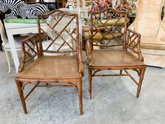 two bamboo chairs sitting next to each other in front of a table with zebras on it