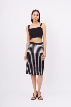 Elevate your wardrobe with the chic and versatile Jule Midi A-Form Skirt, featuring a striking black and ecru vertical stripe pattern. This elegant skirt combines classic design with modern style, making it a perfect addition to any fashion-forward wardrobe.  Crafted from high-quality fabric, the Jule Midi Skirt offers a comfortable and flattering fit that enhances your silhouette. The A-form design creates a graceful, flowing shape that moves beautifully with you, while the vertical stripes add Chic Striped Midi Length Bottoms, Chic Skirt With Striped Hem And Relaxed Fit, Chic Relaxed Skirt With Striped Hem, Black Skirt With Vertical Stripes For Summer, Chic Fitted Skirt With Striped Hem, Chic Striped Midi-length Bottoms, Chic Vertical Stripes Midi Skirt, Chic Midi-length Knit Skirt, Elegant Skirt