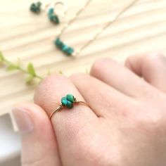 ✨ Raw Turquoise Ring 14K Gold Filled - Sterling Silver, Tiny Raw Stone Stacking Ring, December Birthstone, Pinky ring💙 Dainty & cute stacking ring with genuine Turquoise raw beads. Make a lovely everyday ring, pinky ring, and a wonderful gift.Sizing: •Gemstone Diameter: 4 mm•Ring Band:  0.8 mm ✨ Turquoise is a good luck charm for health and abundance. It is also said to have a therapeutic benefit of tranquility and calmness ✨• Handmade in your ring size with 14K gold-filled or sterling silv Adjustable Turquoise Jewelry For May Birthstone, Dainty 14k Gold Turquoise Gemstone Ring, Dainty 14k Gold Turquoise Ring, Turquoise Birthstone Promise Ring, Green Wire Wrapped Promise Ring, 14k Gold Green Turquoise Ring As A Gift, Green Wire Wrapped Rings, Green Wire Wrapped Rings For Jewelry Making, Turquoise Rings For May Birthstone Gifts