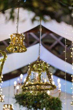 three chandeliers hanging from the ceiling in a room with lights and decorations on it