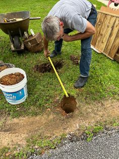 a man digging in the ground with a shovel