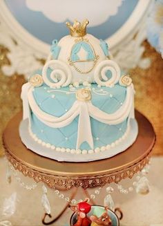 a blue and white cake sitting on top of a table