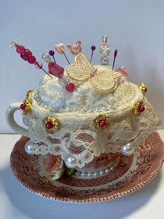 there is a cake that has been decorated with pearls and butterflies on top of it