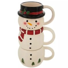 two coffee mugs are stacked on top of each other in the shape of a snowman