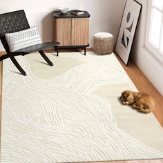 a brown dog laying on top of a rug in a living room next to a chair