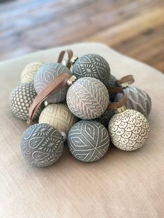 a pile of decorative eggs sitting on top of a table