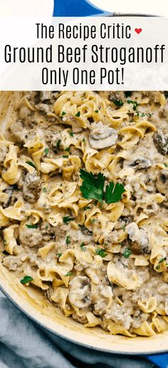 a pan filled with pasta and mushrooms on top of a blue towel