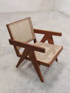 a wooden chair sitting on top of a cement floor