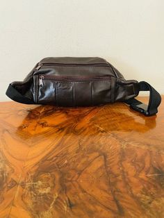 "Brown leather Fanny Pack, Leather ,Hip Bag ,Dark Chocolate Brown Gorgeous soft genuine dark chocolate leather fanny hip bag Made in Mexico 2 side zip pockets 1 back zip pocket 1 front pocket w/velcro closure Top zippered closure PLEASE SEE MEASUREMENTS Measures: 14\" x 6\" x 3\"1/2 Strap: 34' adjustable Excellent condition: clean, looks unused NK246 NK334 Brown leather Fanny Pack, Leather ,Hip Bag ,Dark Chocolate Brown" Brown Leather Shoulder Bag With Zipper Pouch, Brown Soft Leather Travel Belt Bag, Brown Leather Belt Bag With Zipper Closure, Brown Pouch Belt Bag With Pockets, Brown Pouch Belt Bag With Zipper, Brown Belt Bag With Zipper Pouch, Brown Crossbody Belt Bag With Zipper Pouch, Brown Crossbody Belt Bag With Zipper, Leather Hip Bag